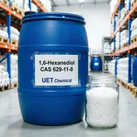 1-6-hexanediol-cas-629-11-8-blue-drum-packaging 1,6-Hexanediol CAS 629-11-8 white crystalline flakes in glass jar beside sealed blue drum with UET Chemical label