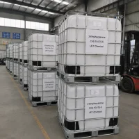 2-ethylhexylamine-cas-104-75-6-ibc-tote-tank Stacked white IBC tote tanks (1000L) of 2-Ethylhexylamine (2-EHA, CAS 104-75-6) in industrial yard with forklift nearby, labeled UET Chemical, ready for shipment