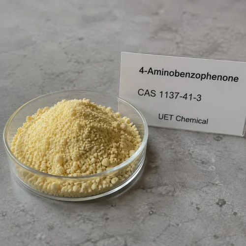 4-aminobenzophenone-cas-1137-41-3-powder-sample 4-Aminobenzophenone CAS 1137-41-3 pale yellow crystalline powder sample displayed in a glass dish for chemical material identification