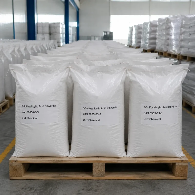 5-sulfosalicylic-acid-dihydrate-white-woven-bag-pallet-stock Rows of white woven bags filled with 5-Sulfosalicylic Acid Dihydrate (CAS 5965-83-3) stacked on wooden pallets in warehouse, labeled UET Chemical, ready for bulk industrial shipment