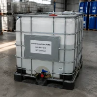 acmo-n-acryloylmorpholine-ibc-tote-tank-warehouse White IBC tote tank with metal cage frame containing N-Acryloylmorpholine (ACMO, CAS 5117-12-4), labeled UET Chemical, positioned in warehouse with blue drums in background, suitable for large-volume industrial use