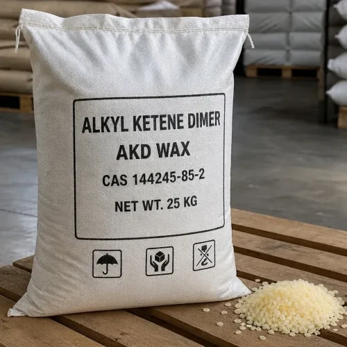 Single 25kg white woven bag of Alkyl Ketene Dimer (AKD Wax) CAS 144245-85-2 on wooden pallet, labeled with handling icons, accompanied by pale yellow flake sample to show physical form for paper sizing applications.