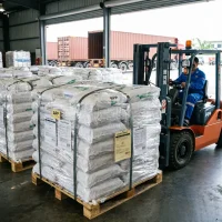 ammonium-polyphosphate-app-pallets-forklift-warehouse-loading Industrial Ammonium Polyphosphate (APP) pallets wrapped in plastic film being moved by a forklift in a warehouse, ready for global container shipping.