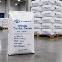 anatase-titanium-dioxide-cas-13463-67-7-25kg-paper-bag-with-label-details A 25kg white paper bag of Anatase Titanium Dioxide CAS 13463-67-7 on the floor, with a detailed label showing net weight, batch number, manufacturing date, shelf life, and storage conditions from UET Chemical.