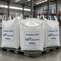 anatase-titanium-dioxide-cas-13463-67-7-three-white-ton-bags-on-pallet Three large white ton bags of Anatase Titanium Dioxide CAS 13463-67-7 on a black plastic pallet in a warehouse, each labeled with UET Chemical branding and 1000kg net weight.