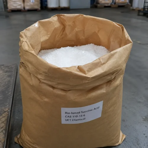 bio-based-succinic-acid-cas-110-15-6-white-crystals-open-bag Open brown paper bag revealing white crystalline Bio-based Succinic Acid CAS 110-15-6 granules, a green chemical raw material for biodegradable plastics and food additives from UET Chemical.