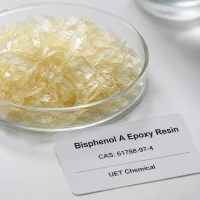 bisphenol-a-epoxy-resin-cas-61788-97-4-solid-sample Pale yellow flaky solid sample of Bisphenol A Epoxy Resin CAS 61788-97-4 in a clear glass dish, with product label showing UET Chemical branding.