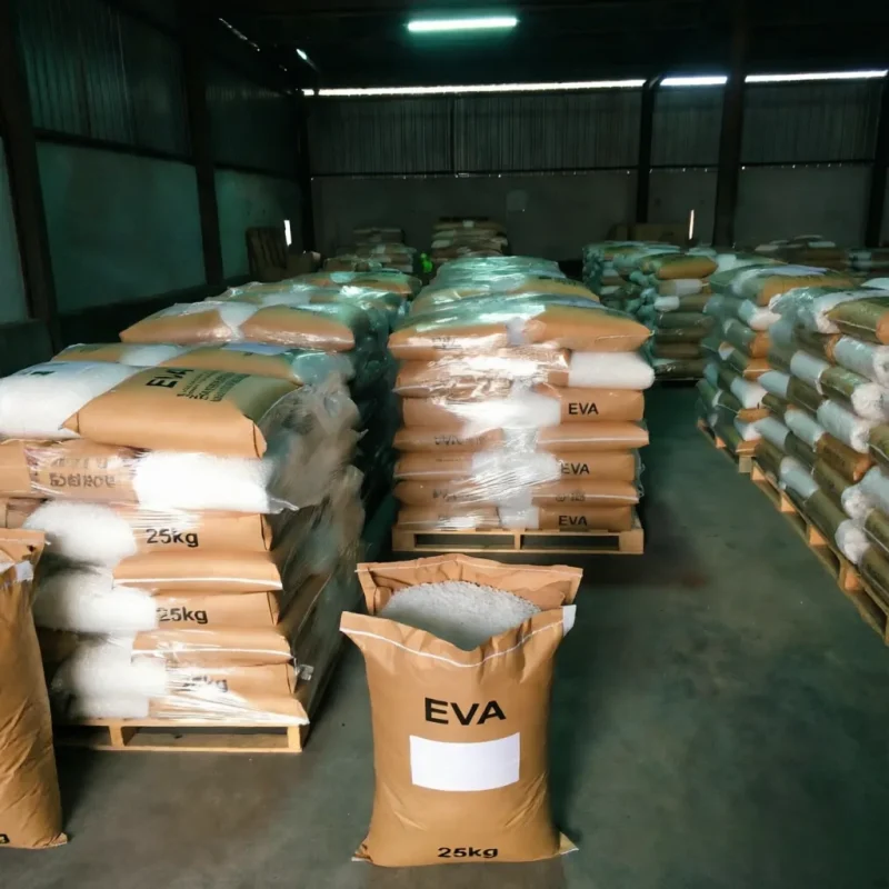 bulk-eva-resin-25kg-bags-on-pallets Bulk storage of EVA resin in standard 25kg kraft paper bags neatly stacked on pallets in a large industrial warehouse, demonstrating a reliable large-scale B2B supply capacity.