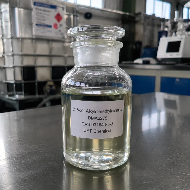 c18-22-alkyldimethylamines-dma2275-cas-93164-85-3-sample-bottle Glass reagent bottle with ground glass stopper containing pale yellow liquid C18-22-Alkyldimethylamines (DMA2275, CAS 93164-85-3) on stainless steel lab bench, labeled UET Chemical, IBC tank visible in background