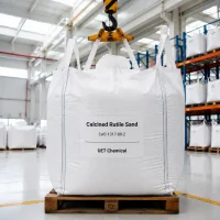 calcined-rutile-sand-fibc-ton-bag-lifting-warehouse Large white FIBC ton bag of Calcined Rutile Sand CAS 1317-80-2 being lifted by a crane in a warehouse loading area, labeled with UET Chemical branding.