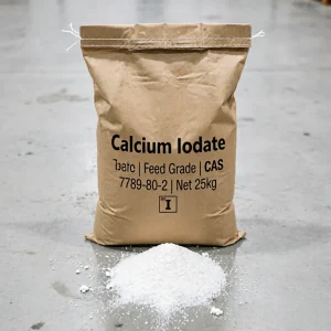 Feed Grade Calcium Iodate (CAS 7789-80-2) 25kg kraft paper bag standing on a warehouse floor, displayed with a pile of white powder and the elemental symbol 'I' for iodine, an essential trace mineral for poultry and livestock feed ingredients.