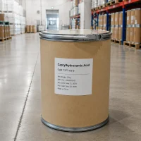 caprylhydroxamic-acid-cas-7377-03-9-25kg-paper-drum-single-unit Single 25kg kraft paper drum of Caprylhydroxamic Acid CAS 7377-03-9 with metal lid and lock, label showing batch number, manufacturing date, expiration date, and 'Made in China', placed in a warehouse aisle.