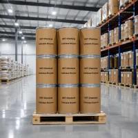 cellulase-enzyme-industrial-drum-packaging-warehouse Stacked industrial fiber drums of Cellulase Enzyme CAS 9012-54-8 on a wooden pallet in a warehouse, labeled with UET Chemical branding, ready for bulk shipment.