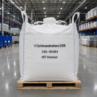 chdm-cas-105-08-8-ton-bag-fibc-bulk-packaging Large white FIBC ton bag of 1,4-Cyclohexanedimethanol (CHDM) CAS 105-08-8 on a wooden pallet in a warehouse, labeled with UET Chemical branding for bulk shipment.
