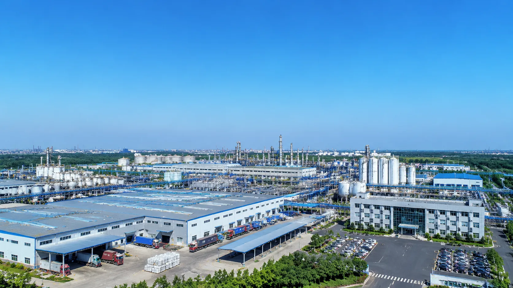 Aerial view of UET Chemical's 15,000 sqm chemical manufacturing factory in China with storage tanks, warehouses and loading docks