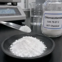 chloroacetamide-cas-79-07-2-white-crystalline-powder-sample White crystalline Chloroacetamide powder (CAS 79-07-2) on a spatula beside a UET Chemical sample bottle, balance in background