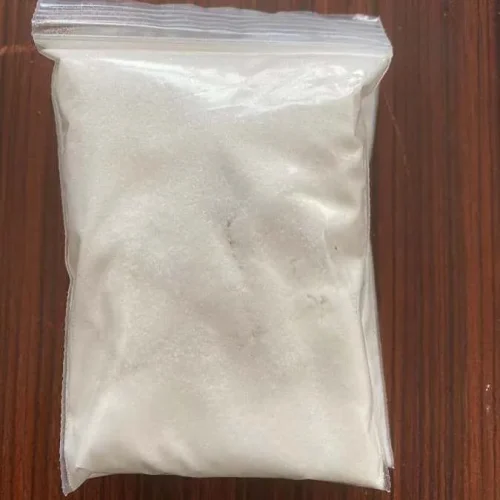 Close-up of white crystalline Chloroxylenol PCMX CAS 88-04-0 powder in a sealed transparent sample bag, showcasing its pure physical texture for antiseptic active ingredient applications.