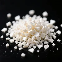 csm-chlorosulfonated-polyethylene-white-granules-crumb-closeup Close-up macro shot of white Chlorosulfonated Polyethylene (CSM) granules and crumbs on a dark surface, highlighting its excellent weather, ozone, and heat resistance for industrial rubber compounds.