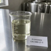 d-limonene-cas-5989-27-5-pale-yellow-liquid-sample-beaker Pale yellow liquid sample of D-Limonene CAS 5989-27-5 in a transparent glass beaker on a metal lab bench, next to a label card showing product name and CAS number.