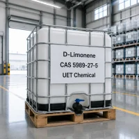 d-limonene-cas-5989-27-5-white-ibc-tote-in-warehouse White IBC tote of D-Limonene CAS 5989-27-5 on a wooden pallet inside a warehouse, labeled with UET Chemical branding and CAS number, ready for bulk shipment.