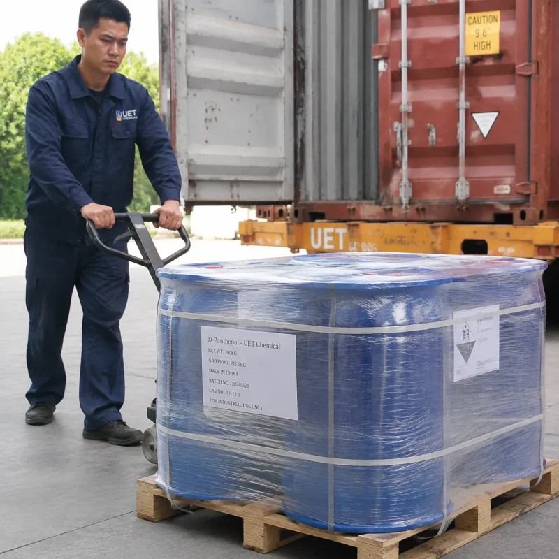 d-panthenol-cas-81-13-0-drums-pallet-container-loading UET worker moving shrink-wrapped 200 kg D-Panthenol (CAS 81-13-0) drums on a pallet jack toward an export container