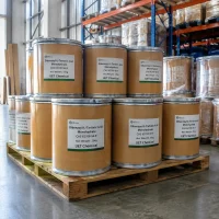 dibenzoyl-l-tartaric-acid-monohydrate-25kg-drum-pallet Multiple 25kg brown metal drums of Dibenzoyl-L-Tartaric Acid Monohydrate (CAS 62708-56-9) stacked on pallet, labeled UET Chemical, in chemical storage facility
