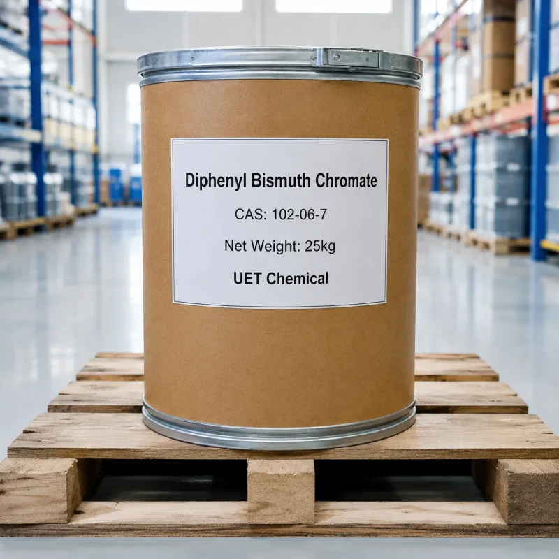 diphenyl-bismuth-chromate-cas-102-06-7-25kg-fiber-drum-packaging Brown fiber drum of Diphenyl Bismuth Chromate CAS 102-06-7 with white label showing net weight 25kg and UET Chemical branding, placed on a wooden pallet in a warehouse.