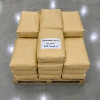 diphenyl-bismuth-chromate-cas-102-06-7-brown-paper-bag-pallet Stacked brown paper bags of Diphenyl Bismuth Chromate CAS 102-06-7 on a wooden pallet, with central bag labeled UET Chemical and product details, viewed from above in a warehouse.