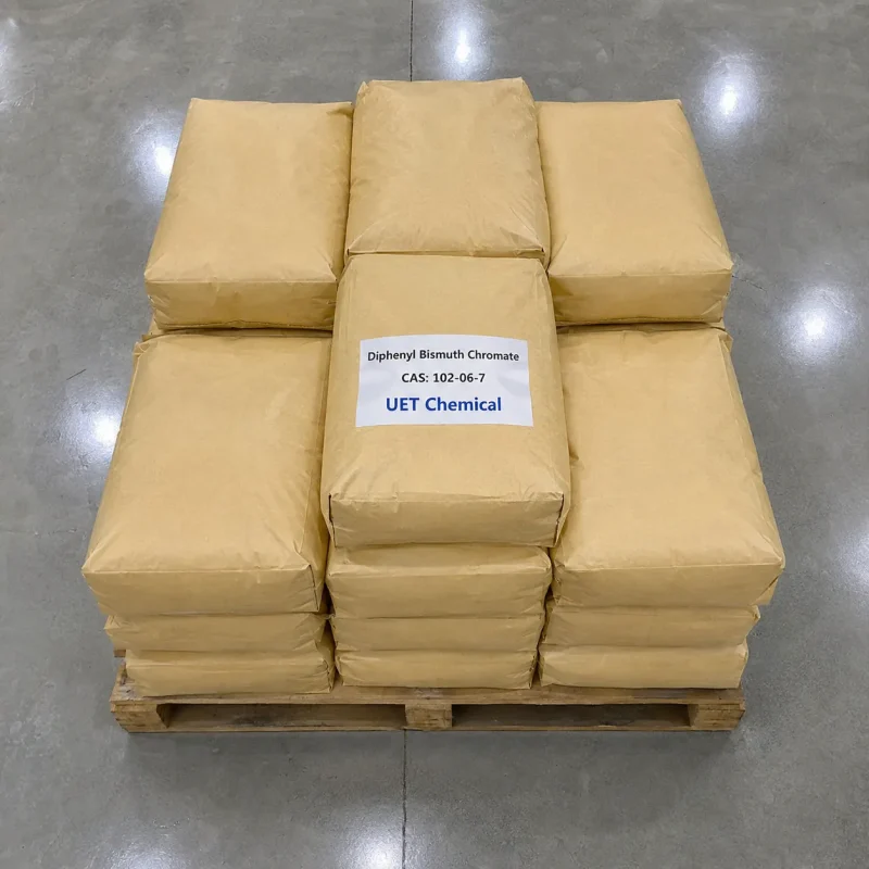 diphenyl-bismuth-chromate-cas-102-06-7-brown-paper-bag-pallet Stacked brown paper bags of Diphenyl Bismuth Chromate CAS 102-06-7 on a wooden pallet, with central bag labeled UET Chemical and product details, viewed from above in a warehouse.