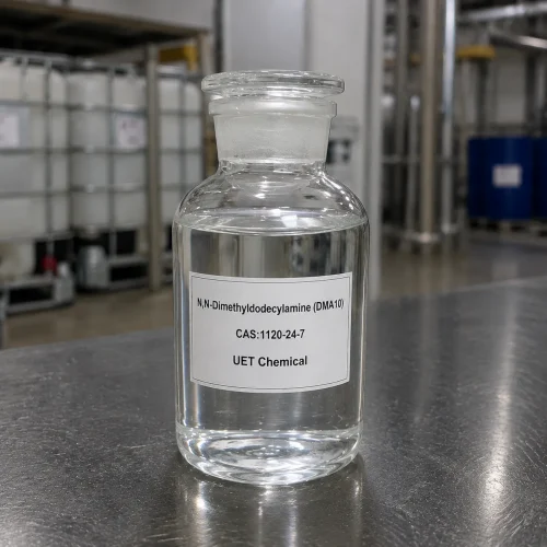 dma10-nn-dimethyldecylamine-clear-liquid-sample-bottle Clear glass reagent bottle filled with colorless liquid N,N-Dimethyldecylamine (DMA10, CAS 1120-24-7) on stainless steel table, labeled UET Chemical, sample for surfactant and chemical intermediate verification