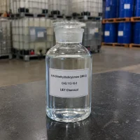 dma12-clear-liquid-sample-glass-reagent-bottle-u-et-chemical Clear glass reagent bottle filled with colorless liquid N,N-Dimethyldodecylamine (DMA12, CAS 112-18-5) on dark table surface, labeled UET Chemical, high purity sample for laboratory testing and quality inspection