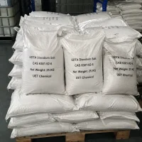 edta-disodium-salt-cas-6381-92-6-25kg-bulk-bags-warehouse Stacks of 25kg white woven bags containing EDTA Disodium Salt CAS 6381-92-6 on a wooden pallet in a warehouse, supplied by UET Chemical.