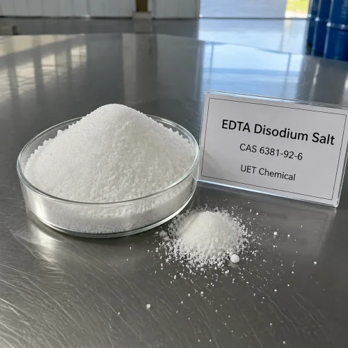 edta-disodium-salt-cas-6381-92-6-white-crystalline-powder-sample White crystalline powder of EDTA Disodium Salt CAS 6381-92-6 in a glass dish with a product label from UET Chemical.