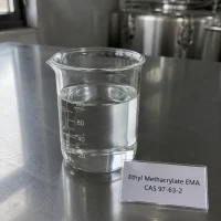 Clear liquid sample of Ethyl Methacrylate EMA CAS 97-63-2 in a transparent glass beaker on a metal lab bench, next to a label card showing product name and CAS number.