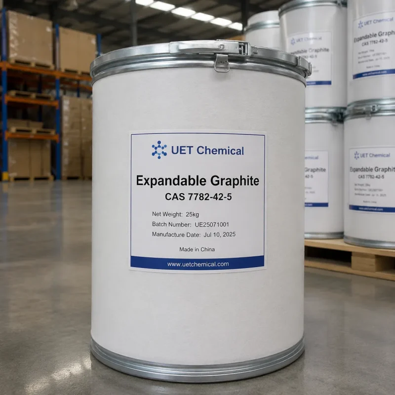 expandable-graphite-cas-7782-42-5-25kg-white-fiber-drum-uet-chemical A 25kg white fiber drum of Expandable Graphite CAS 7782-42-5 with metal clasp lid, labeled with batch number UE25071001 and manufacture date Jul 10, 2025, by UET Chemical in warehouse.