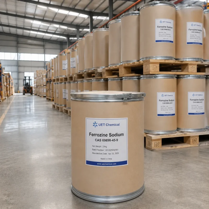ferrozine-sodium-cas-69898-45-9-25kg-paper-drum-pallet-warehouse Stack of 25kg paper drums of Ferrozine Sodium CAS 69898-45-9 on wooden pallets in warehouse, labeled with batch number UE2025042301 and manufacture date Apr 23, 2025, by UET Chemical.
