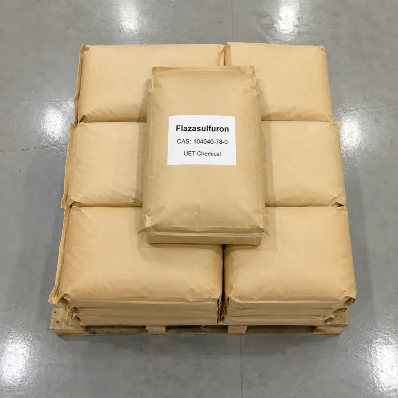 flazasulfuron-cas-104040-78-0-kraft-paper-bag-stack-pallet Stack of kraft paper bags of Flazasulfuron CAS 104040-78-0 on a wooden pallet in a warehouse, each bag labeled with product name, CAS number, and UET Chemical branding.
