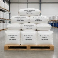 guanidine-hydrochloride-cas-50-01-1-25kg-woven-bag-packaging Stacked white woven bags of Guanidine Hydrochloride CAS 50-01-1 on wooden pallets in a warehouse, labeled with product name, CAS number, and net weight, ready for bulk shipment.
