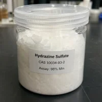 hydrazine-sulfate-cas-10034-93-2-white-crystal-sample-jar-98-assay Clear plastic jar showing white crystalline Hydrazine Sulfate CAS 10034-93-2 with a minimum 98% assay label, highlighting its high purity for laboratory and industrial chemical synthesis.