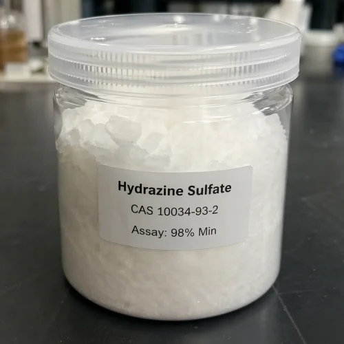 Clear plastic jar showing white crystalline Hydrazine Sulfate CAS 10034-93-2 with a minimum 98% assay label, highlighting its high purity for laboratory and industrial chemical synthesis.
