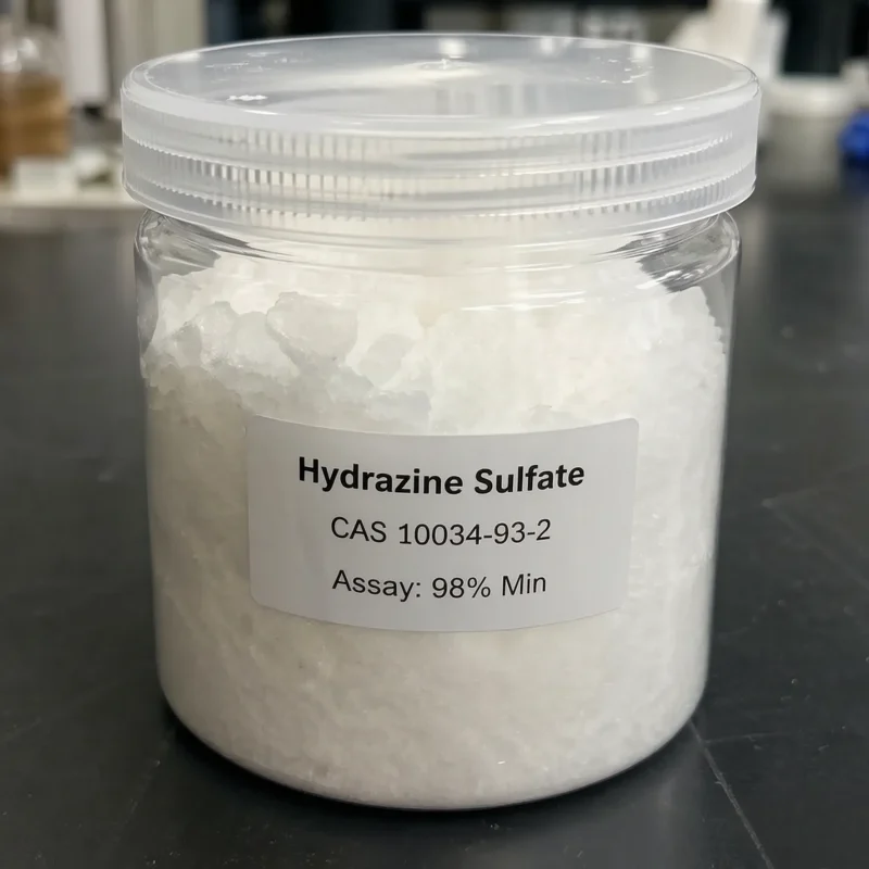 hydrazine-sulfate-cas-10034-93-2-white-crystal-sample-jar-98-assay Clear plastic jar showing white crystalline Hydrazine Sulfate CAS 10034-93-2 with a minimum 98% assay label, highlighting its high purity for laboratory and industrial chemical synthesis.