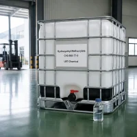 hydroxyethyl-methacrylate-cas-868-77-9-white-ibc-tote-tank-with-sample White IBC tote tank of Hydroxyethyl Methacrylate CAS 868-77-9 with a small sample bottle in front, placed on a warehouse floor with a forklift visible in the background, label showing UET Chemical.