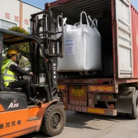 itaconic-acid-cas-97-65-4-1000kg-jumbo-bag-container-loading Forklift loading a 1000 kg jumbo bag of Itaconic Acid (CAS 97-65-4) into a container for export shipment