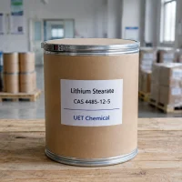 lithium-stearate-cas-4485-12-5-kraft-paper-drum-in-warehouse Kraft paper drum of Lithium Stearate CAS 4485-12-5 on a wooden pallet in a warehouse, labeled with UET Chemical branding.