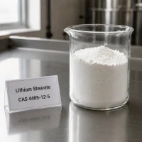 lithium-stearate-cas-4485-12-5-white-powder-sample-beaker White powder sample of Lithium Stearate CAS 4485-12-5 in a transparent glass beaker on a metal lab bench, next to a label card showing product name and CAS number.
