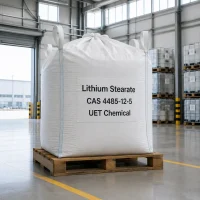 lithium-stearate-cas-4485-12-5-white-ton-bag-in-warehouse Large white ton bag of Lithium Stearate CAS 4485-12-5 on a wooden pallet inside a warehouse, labeled with UET Chemical branding.