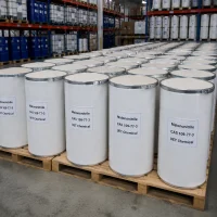 malononitrile-cas-109-77-3-white-fiber-drum-bulk-warehouse Rows of white fiber drums with metal hoops containing Malononitrile (CAS 109-77-3) on wooden pallets in warehouse, labeled UET Chemical, bulk industrial packaging for chemical synthesis applications