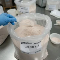 manganese-carbonate-598-62-9-powder-sample-scoop Light pink manganese carbonate powder CAS 598-62-9 scooped from bag showing fine texture and purity