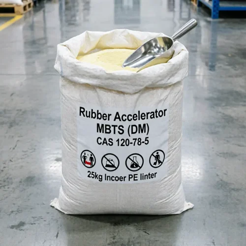 One of our 25kg rubber accelerator MBTS (DM) bags sitting open in the warehouse. A stainless steel scoop is resting inside the pale yellow granules. The label clearly marks the product, CAS 120-78-5, and the inner PE liner, which keeps the rubber chemical safe from moisture before use.