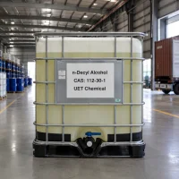 n-decyl-alcohol-cas-112-30-1-ibc-tote-bulk-liquid-packaging Bulk liquid packaging of n-Decyl Alcohol CAS 112-30-1 in a white IBC tote with metal cage, labeled with UET Chemical brand in an industrial warehouse.